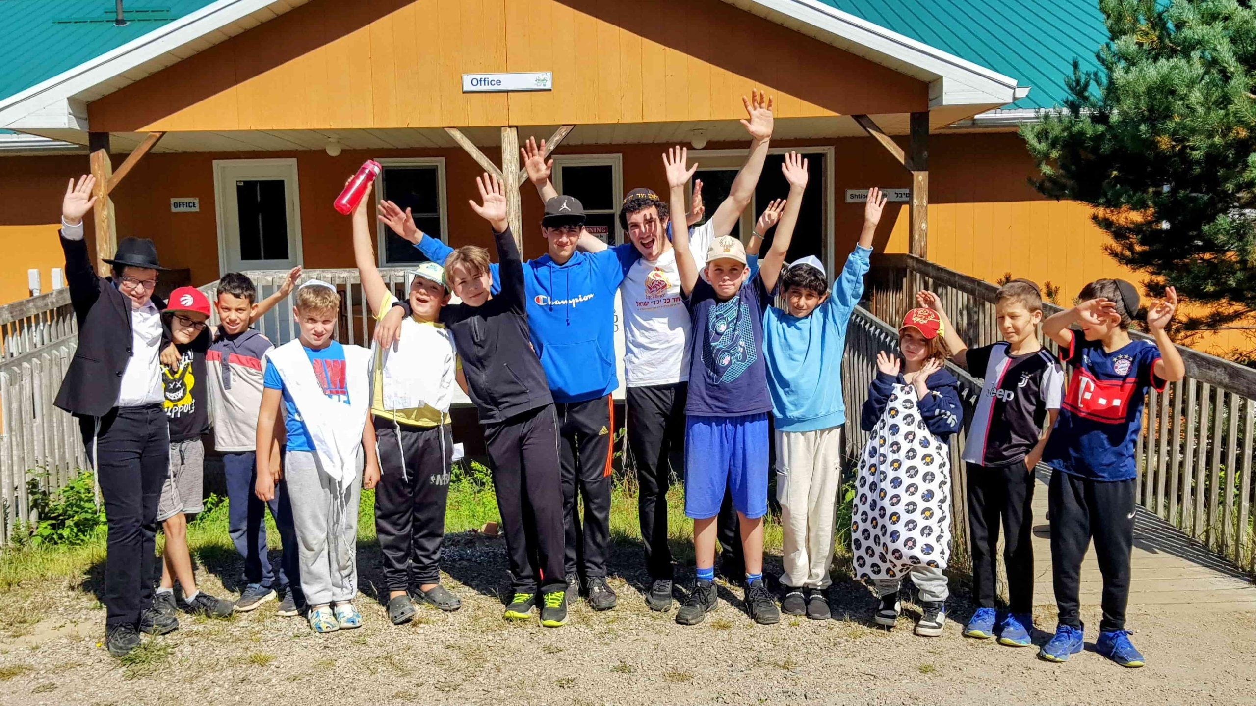 group photo at camp chai in front of cabin