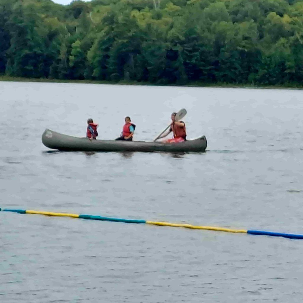 three people in canoe
