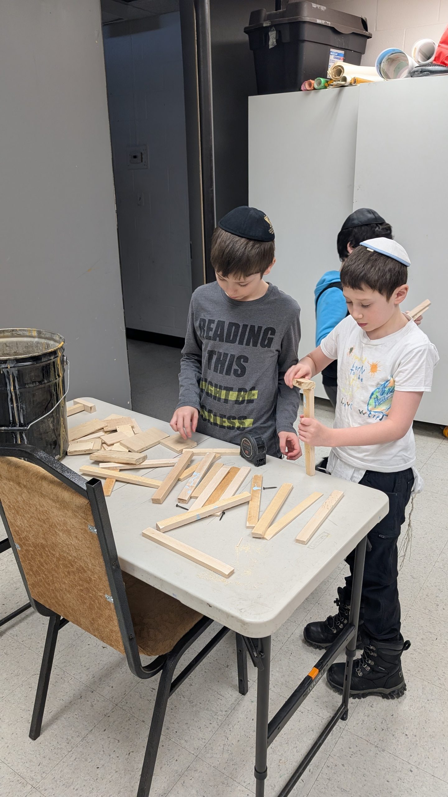 two young boys participating in woodworking class